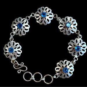 Silver Toned Link Floral Motif Bracelet with Blue Stone Center Accents